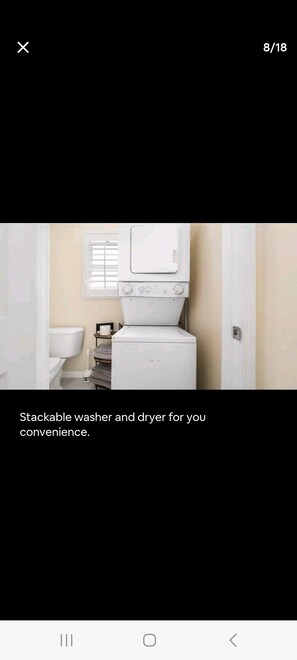 A bathroom with a stackable washer and dryer.