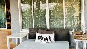 A modern bedroom with a large window, a bed, a small table, and a wicker basket. - Seaside home for families and furry friends! (Pranburi)
