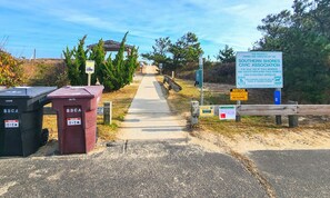 A gated entrance with a pathway leading to a building, surrounded by trees and a clear sky. - Sorrento - Enjoy Sound Views from this Soundside Home w/Private Pool (Southern Shores)