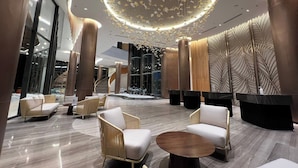 A modern lobby with a central chandelier, seating areas, and a staircase. - Cam Ranh Mystery Villas & Resort (Cam Lam)
