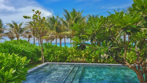 A swimming pool with a view of the ocean and palm trees. - Cam Ranh Mystery Villas & Resort (Cam Lam)