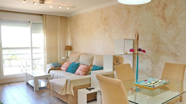 A modern bedroom with a bed, bedside table, and a glass dining table with chairs. - Apartment Angel in San Fernando (San Fernando)
