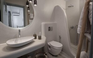 A modern bathroom with a large oval sink, a toilet, and a shower area. - Iliada Suites Adults Only (Naxos)