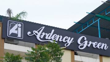 A sign for 'Ardency Green' with a symbol indicating a restaurant or cafe.