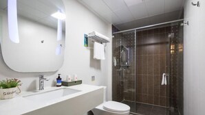 A modern bathroom with a white sink, a toilet, and a glass-enclosed shower. - YUEFENG HOTEL(Guangzhoupanyu) (Guangzhou)