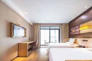 A hotel room with a bed, a desk, a chair, a TV, and a large window. - IU Hotel (Yanshi Baima Temple) (Luoyang)