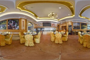 A spacious dining area with round tables and chairs, a central chandelier, and artwork on the walls. - Vienna Hotel (Huizhou Qiuchang Yingbin Road) (Huizhou)
