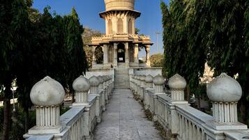 A pathway leading to a domed structure with ornate railings and balustrades.