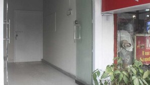 A hotel entrance with a sign indicating 'SHADNI Booking No 58-9' and a direction to 'A Project - Royal Plaza'. - Hotel Shadman (Lahore)