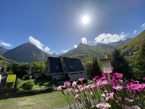 A mountain landscape with a house and a street.