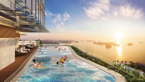 Relax by the rooftop infinity pool overlooking the ocean and distant islands.