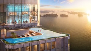 Relax by the rooftop infinity pool with panoramic views of the surrounding water and distant islands.