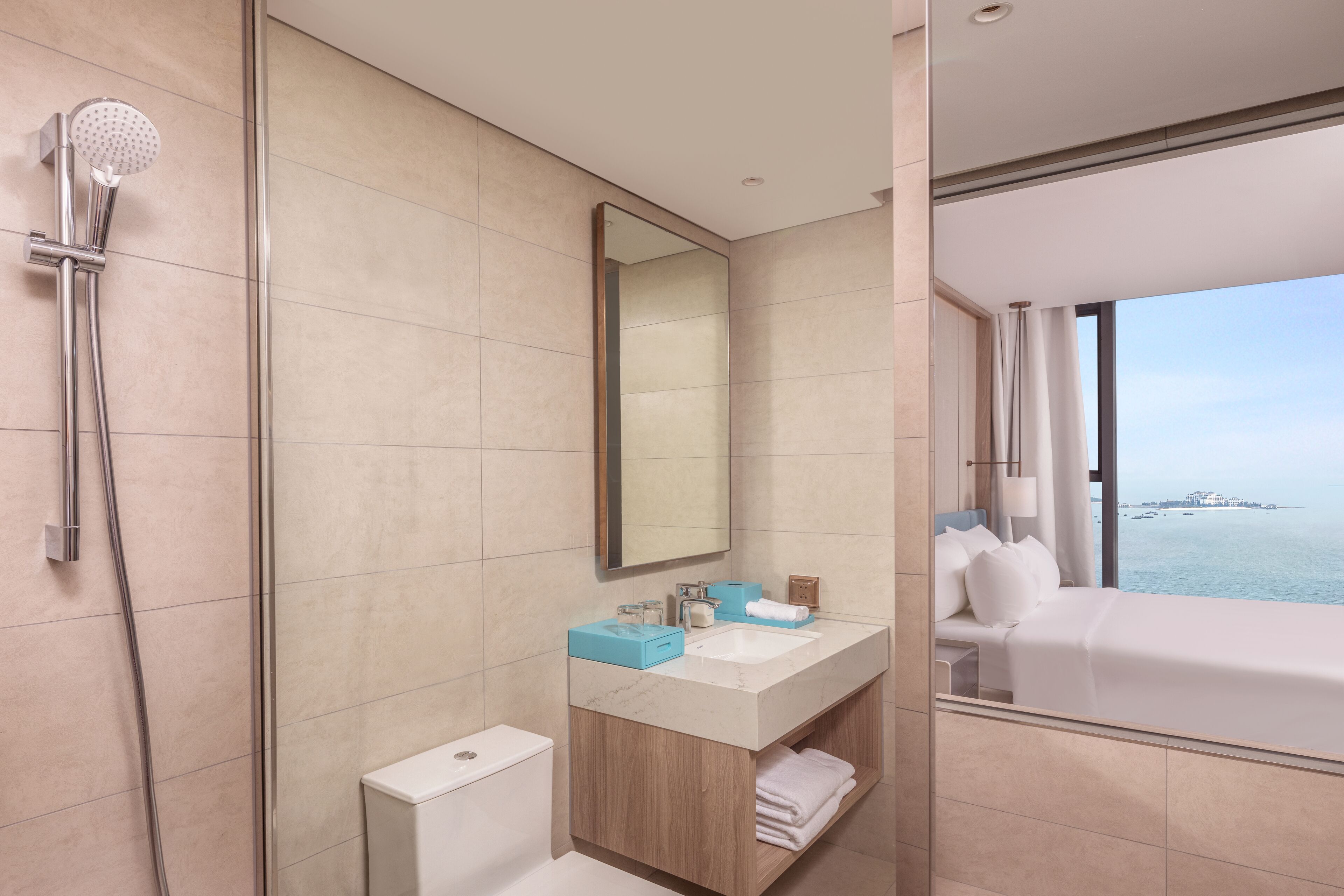 A modern bathroom with a shower, sink, and a large mirror.