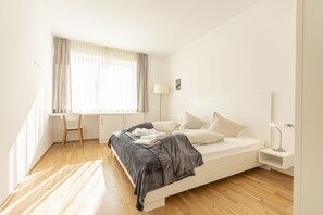 A minimalist bedroom with a bed, a desk, and a chair. - Pleasant chalet on the ski slopes (St. Lambrecht)