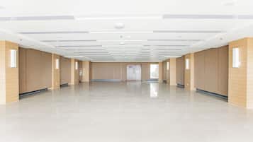 A spacious, modern interior with a high ceiling, recessed lighting, and a polished floor.