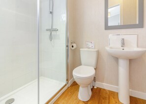 A bathroom with a glass shower enclosure, a white toilet, and a pedestal sink. - 2 bedroom accommodation in Swinethorpe, Nr Lincoln (Swinethorpe, Nr Lincoln)