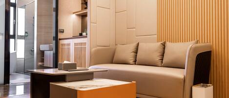 A modern living room with a sofa, a coffee table, and a TV.