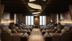 A luxurious lounge with leather sofas arranged in a semi-circle, a central coffee table, and a decorative ceiling with leaf patterns. - Cat Ba Paradise Hotel - Sky Bar & Massage  (Hai Phong)