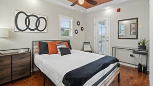 A bedroom with a bed, a desk, a ceiling fan, and a window. - Live-Love-St Pete! Hipster 1 bdrm Studio in DTSP!! (St. Petersburg)