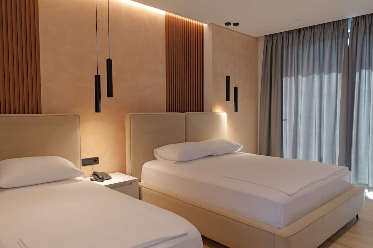 Deluxe Triple Room, Sea View | Hypo-allergenic bedding available, desk, laptop workspace, soundproofing