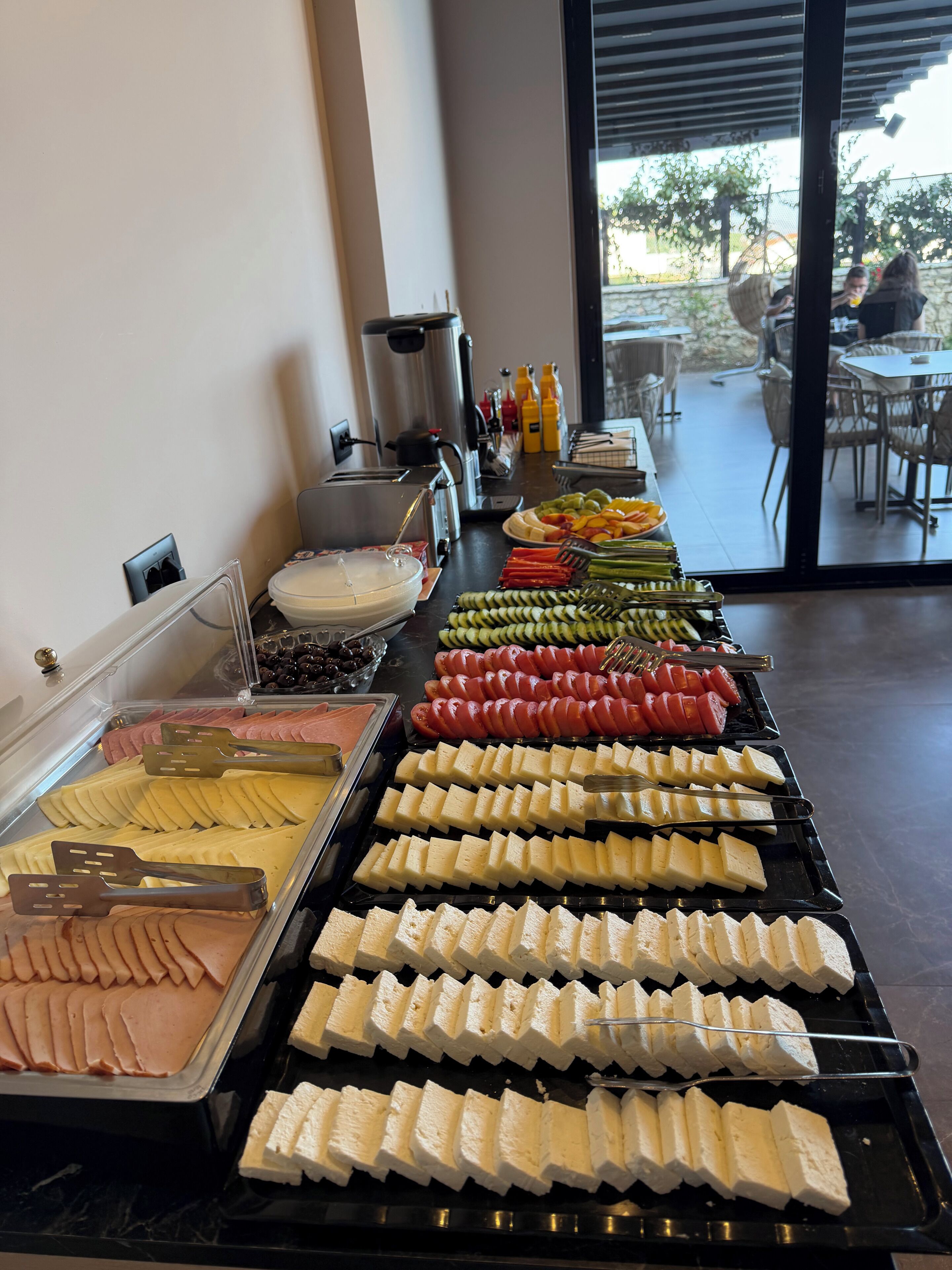 A buffet with various food items and utensils.