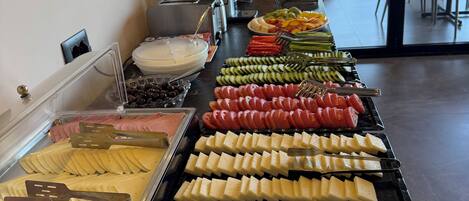 A buffet with various food items and utensils.