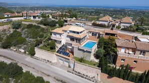 A residential area with houses, a swimming pool, and solar panels.