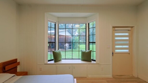 A bedroom with a large window, a bed, and a door. - Vacation home ,silver springs, salt spring ,Ocala world equestrian center.  (Ocala)