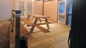 An outdoor deck with a picnic table and string lights. - Vacation home ,silver springs, salt spring ,Ocala world equestrian center.  (Ocala)