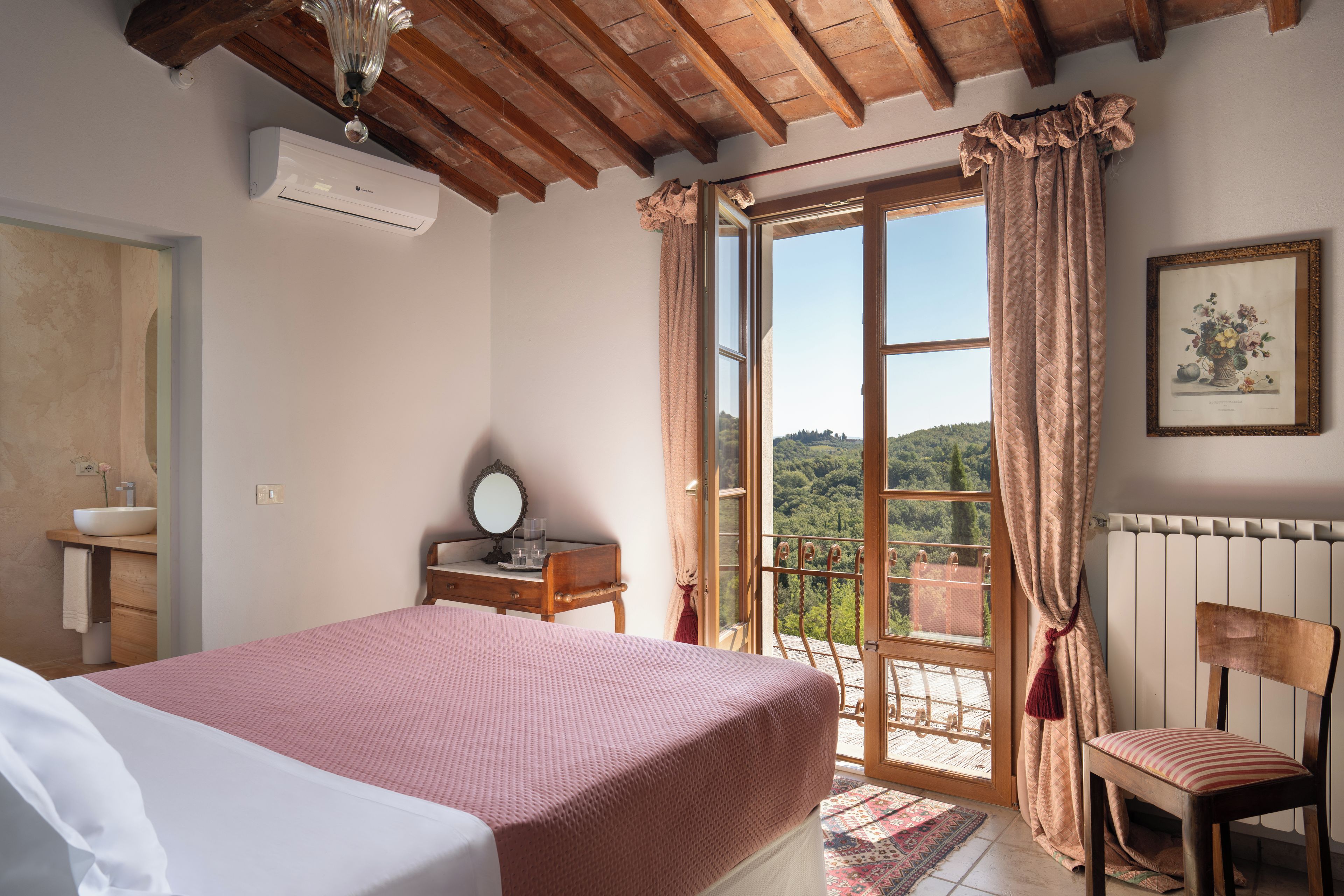 A bedroom with a bed, a dresser, a mirror, a window with curtains, and a radiator.