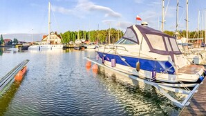 A marina with several boats docked, calm water, and a clear sky. - Amazing home in Nowecin with WiFi (Nowecin)