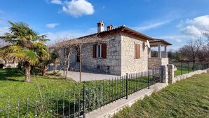 A stone house with a tiled roof, a balcony, and a satellite dish. - Gorgeous home in Nedescina (Nedescina)