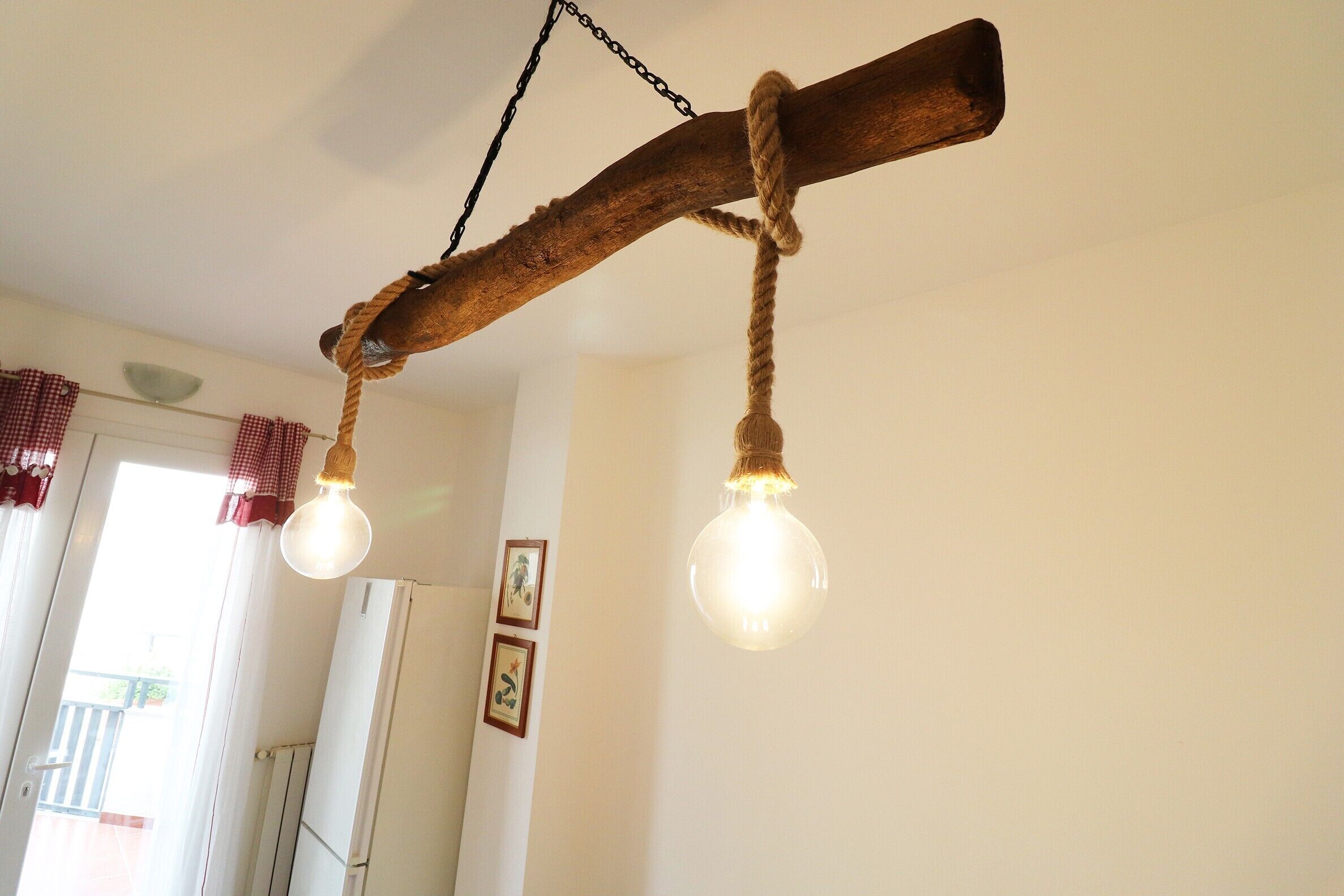 A rustic wooden ceiling with two spherical light fixtures.