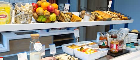 A breakfast buffet with various food items and condiments.
