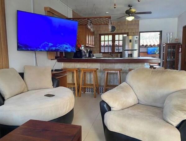 Relax in comfort with a spacious seating area, flat-screen TV, and fully equipped kitchen.