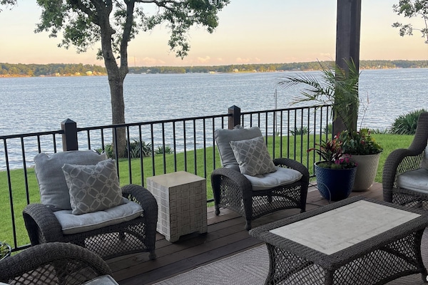 Main level deck with covered patio living room, dining, and hot tub