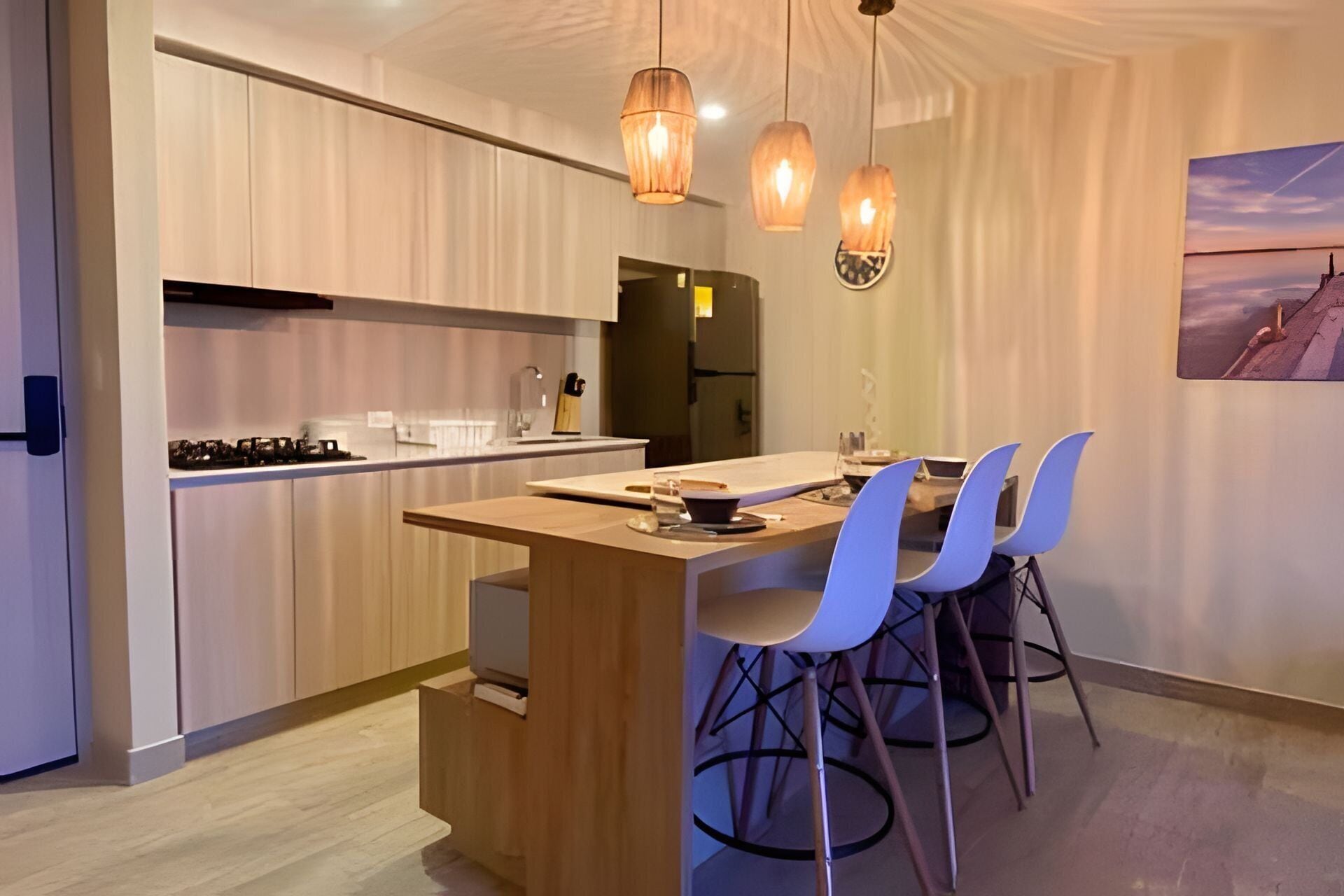 A modern kitchen with wooden cabinets, a central island, and pendant lighting.