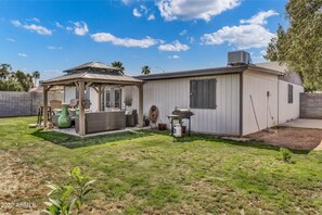 A single-story mobile home with a covered patio area.