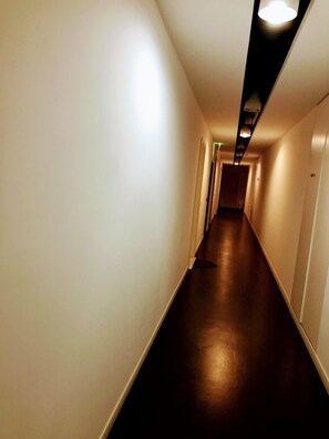 Stroll down this serene hallway lined with doors to various rooms.