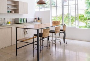 Fridge, microwave, coffee/tea maker, cookware/dishes/utensils