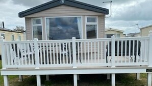 A mobile home with a white deck and a large window. - M697 - 8 berth with veranda - Pet Friendly (Camber)
