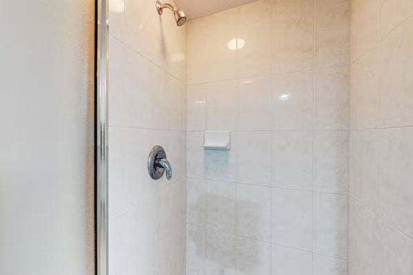 A shower with a glass door and a chrome faucet. - Destin West - Sandpiper 407 (Okaloosa Island)