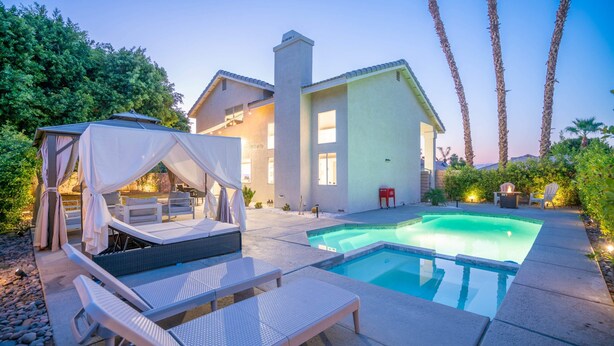 A modern house with a swimming pool, outdoor seating, and a covered area. - The Great Escape: Pool Home Oasis in the Desert (Indio)
