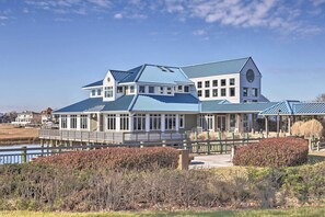 A large, modern building with a blue roof and a covered walkway. - Pool, Canal Views! Unit 1/2 Mi to Ocean City Beach (Ocean City)