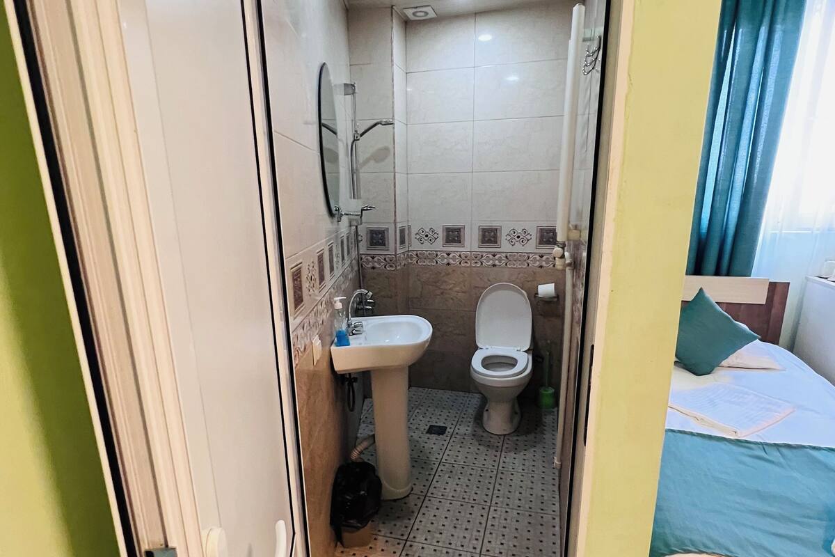 standard quadruple room | bathroom | shower, hair dryer, slippers, towels