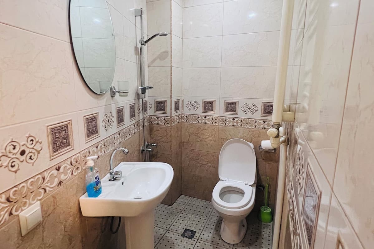 standard quadruple room | bathroom | shower, hair dryer, slippers, towels