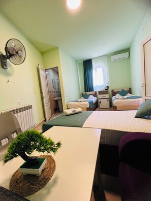 Standard Quadruple Room | Desk, blackout drapes, iron/ironing board, free WiFi