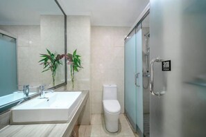 A modern bathroom with a sink, toilet, and glass shower enclosure. - Meiyi Meijia Hotel (Xiangyang Nanzhang) (Nanzhang)