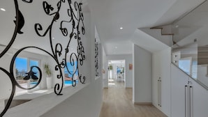 A modern interior with a staircase, white walls, and a view of the outdoors. - Villa Simply White with Pool (Makarska)