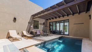 A swimming pool with lounge chairs and a covered patio area. - Overlake: Private Pool + Large Groups + Sand Dunes (Hurricane)